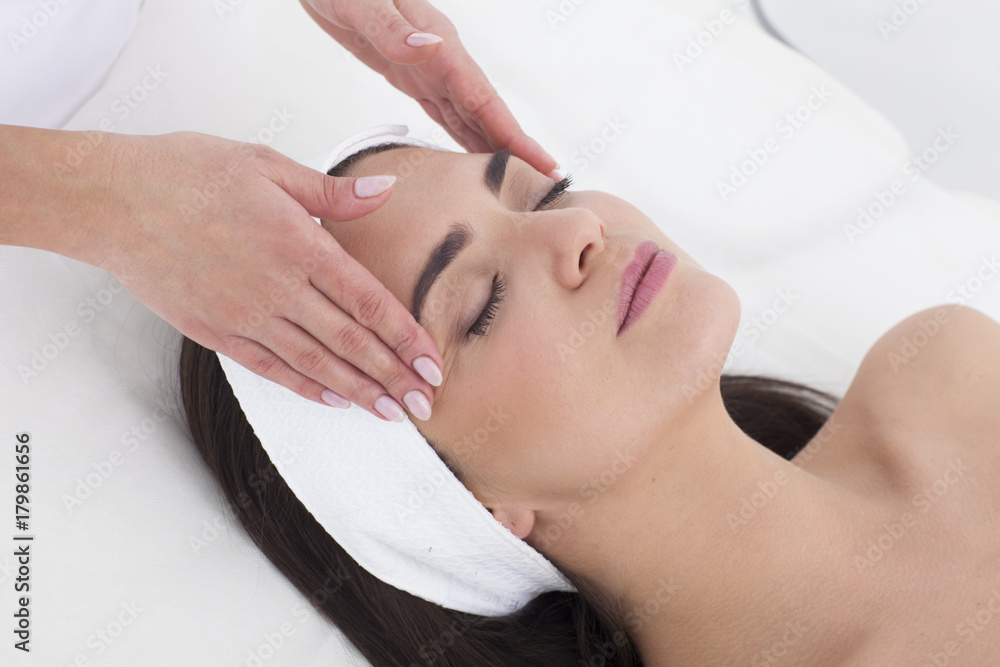 Beautiful woman in Spa having a facial massage. Beautiful woman in Spa having a facial massage.