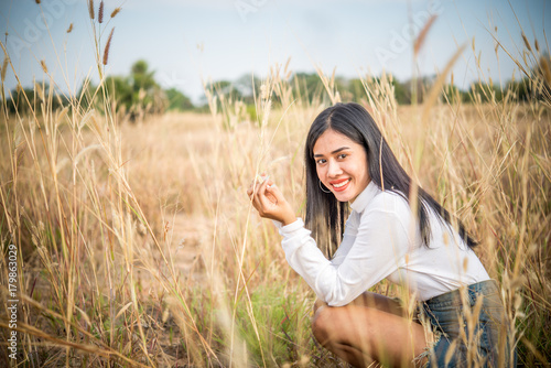 Sad asian woman smiling at field vintage style,she very happy from love