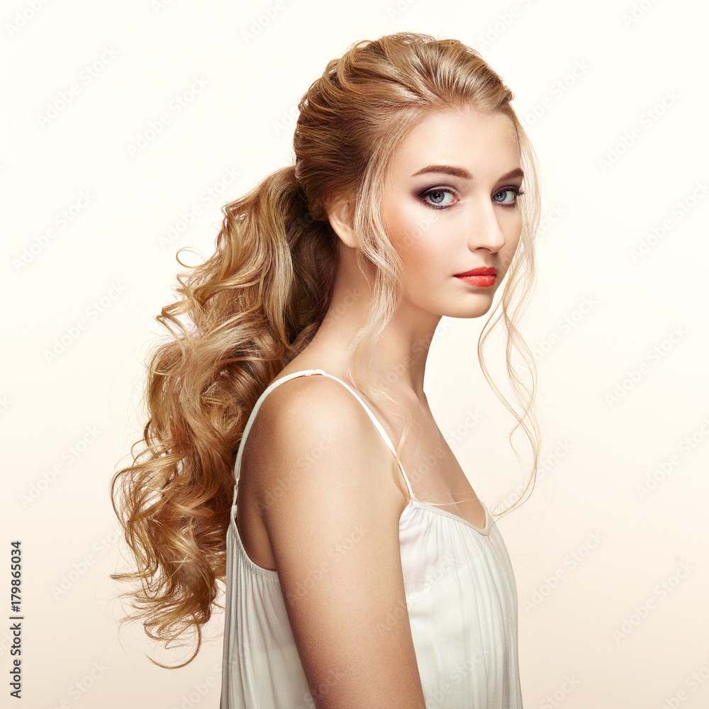 Blonde Girl with Long and shiny Curly Hair. Beautiful Model Woman with Curly  Hairstyle. Care and Beauty Hair products. Perfect Make-Up and Jewelry Stock  Photo | Adobe Stock