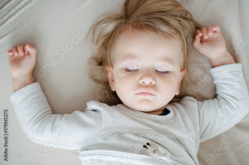 Beautiful toddler sleeping in bed