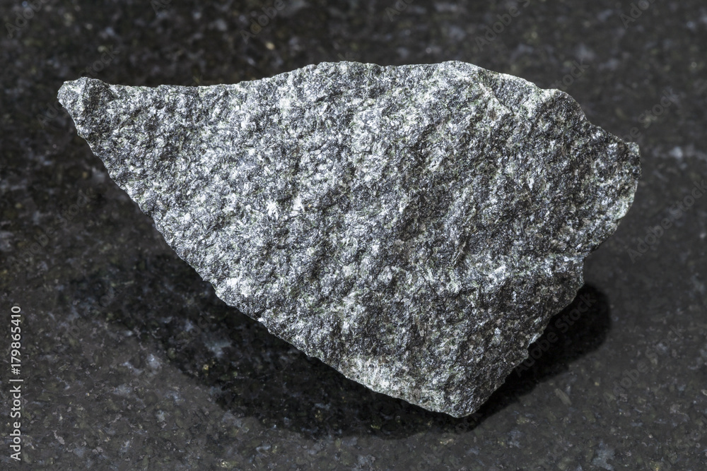 raw dolerite stone on dark background raw dolerite stone on dark background
