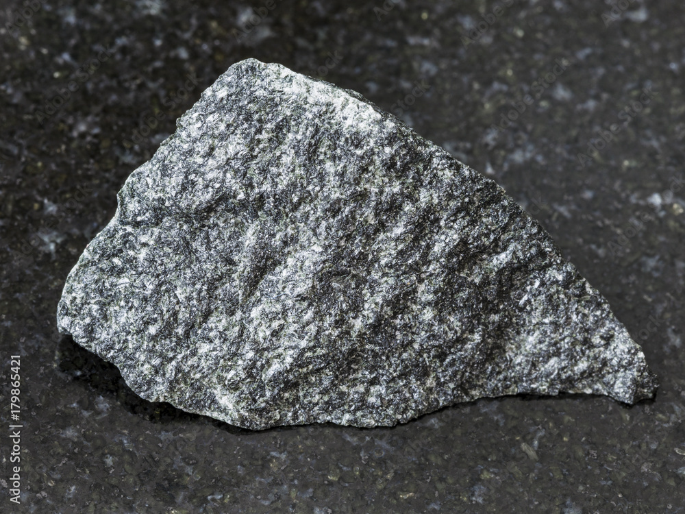 rough dolerite stone on dark background rough dolerite stone on dark background