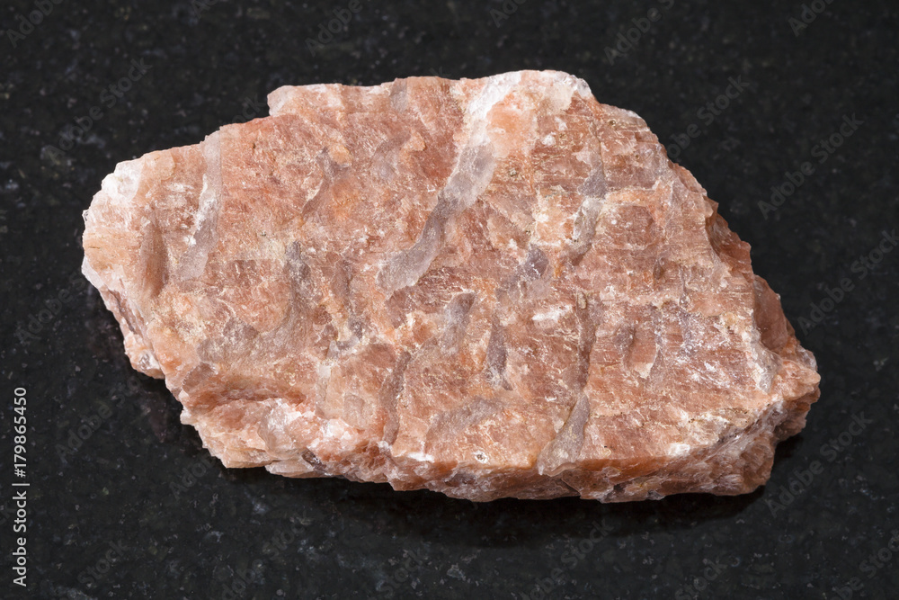 slab from raw pegmatite stone on dark