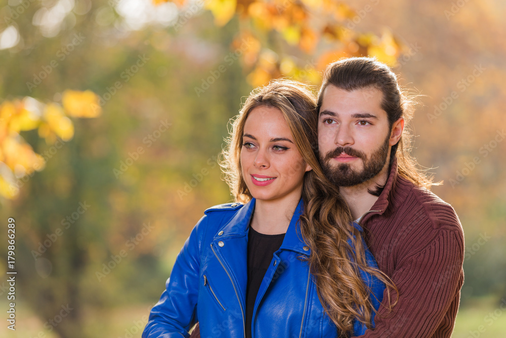 Cute couple in park filled with autumn colors. Cute couple in park filled with autumn colors.