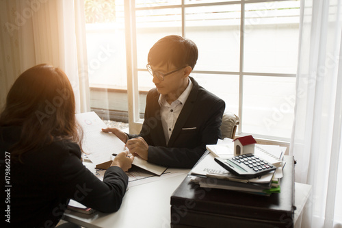 The hard work of an asian lawyer in a lawyer's office. Counseling and giving advice and prosecutions about the invasion of space between private and government officials to find a fair settlement. photo