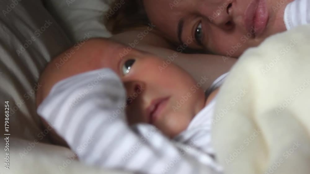 Mother and her Newborn Baby. Happy Mother and Baby kissing and hugging. Resting in bed together. Maternity concept. Parenthood. Motherhood Beautiful Happy Family Stock Video Footage. Mother and her Newborn Baby. Happy Mother and Baby kissing and hugging. Resting in bed together. Maternity concept. Parenthood. Motherhood Beautiful Happy Family Stock Video Footage.