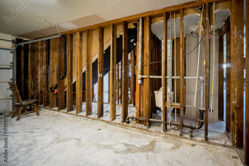 Bare walls of a flooded home after drywall and floors have been removed photo