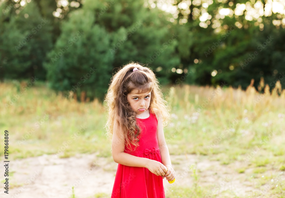 Portrait of cute sad little girl looking worried at summer day Portrait of cute sad little girl looking worried at summer day