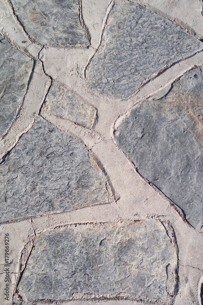 Fototapeta premium Old stone wall. Uneven rough stones of different shapes. Stone background.