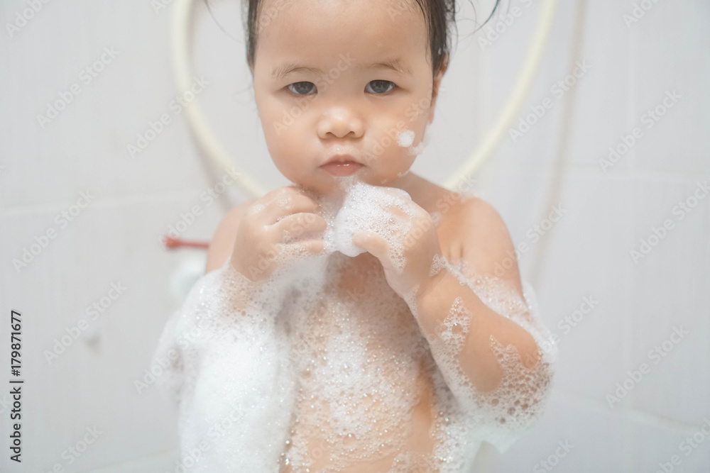 custom made wallpaper toronto digitalLittle asian girl taking shower in bathroom, playing bath foam bubbles. Selective focus