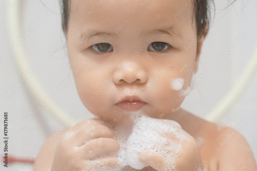 custom made wallpaper toronto digitalLittle asian girl taking shower in bathroom, playing bath foam bubbles. Selective focus