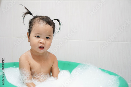 Wallpaper Mural Little asian girl taking bath foam bubbles in bathtub, Toddler 1.8 years old taking bath by herself Torontodigital.ca