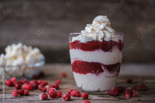 cottage cheese dessert with berry sauce in a glass beaker