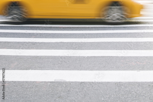 Abstract blur of urban street scene with a yellow taxi cab in New York, United States