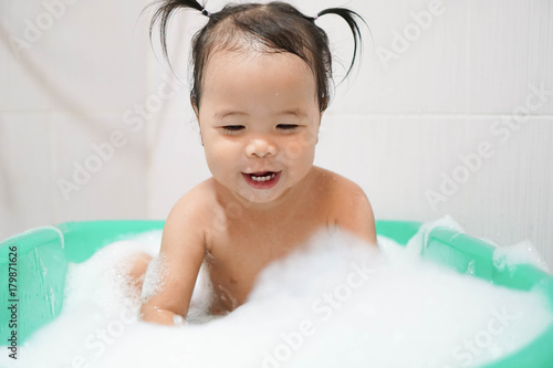 Wallpaper Mural Happy little asian girl taking bath foam bubbles in bathtub, Toddler 1.8 years old taking bath by herself Torontodigital.ca