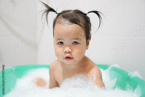 Wallpaper Mural Little asian girl taking bath foam bubbles in bathtub, Toddler 1.8 years old taking bath by herself Torontodigital.ca