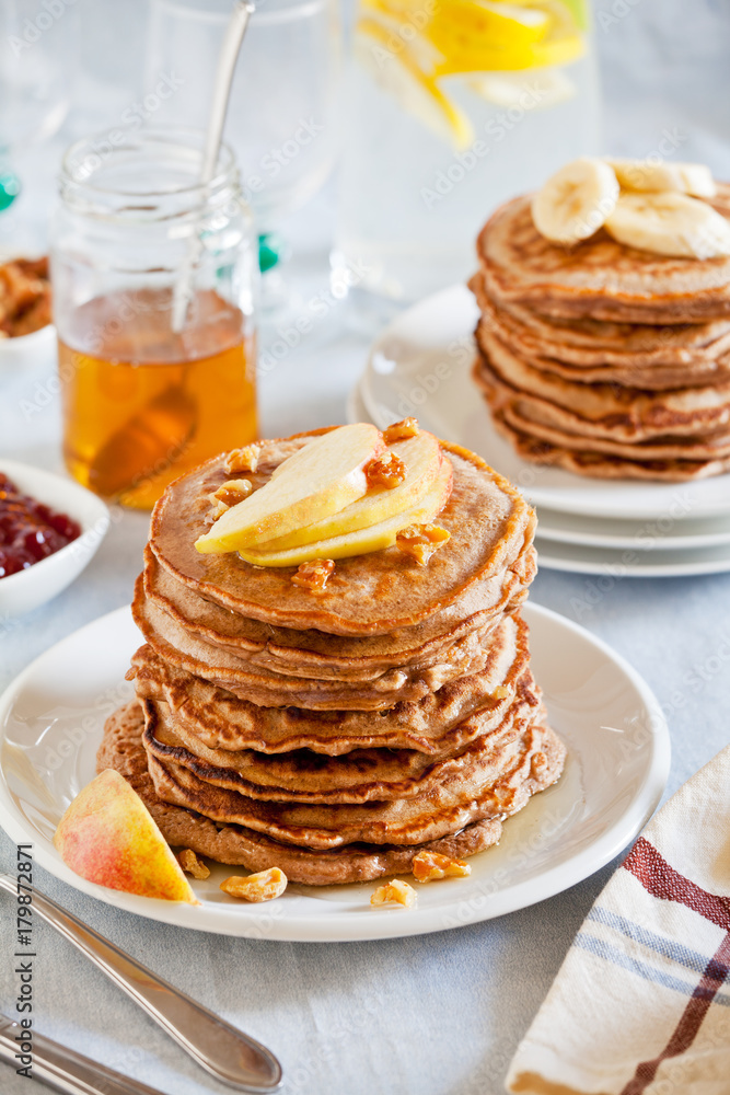 Stacks Of Whole Wheat Pancakes With Apple And Banana Slices Stacks Of Whole Wheat Pancakes With Apple And Banana Slices