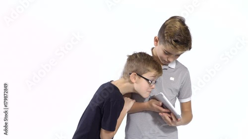 Boy hides from little brother what he doing on tablet