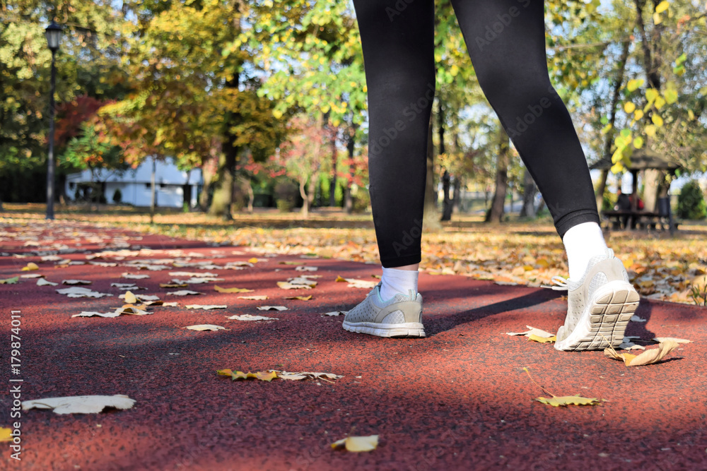 Fototapeta premium Recreation in the park during fall season - jogging and walking