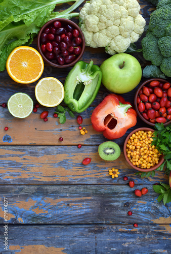 Composition of products containing ascorbic acid  vitamin C - citrus  cauliflower  broccoli  sweet pepper  kiwi  dog rose  tomatoes  apple  currant  sea buckthorn  dogwood. Top view. Flat lay.