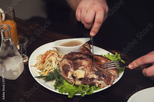 Man eats tasty dish of pork...
