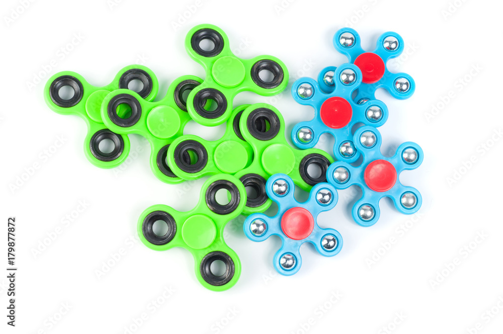 Various colored fidget spinners - stress relieving toys on a white background Various colored fidget spinners - stress relieving toys on a white background