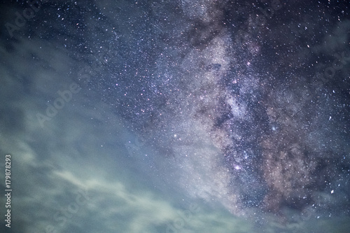 Long exposure and High ISO shot of star and milky way over the sky with moving clouds at night.