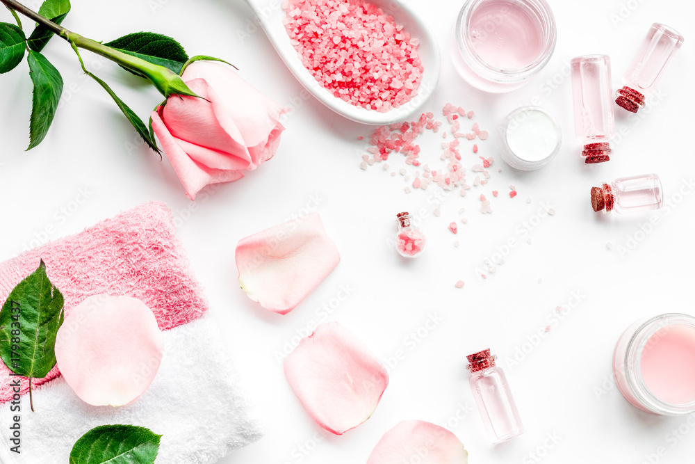 Natural organic cosmetics with rose oil. Cream, lotion, spa salt on white background top view Natural organic cosmetics with rose oil. Cream, lotion, spa salt on white background top view