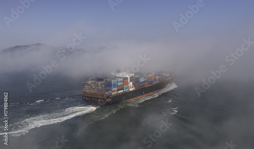Fotografie Cargo ship in the fog