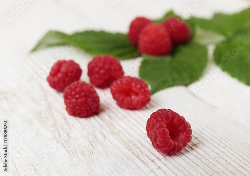 Raspberries on a wooden white table