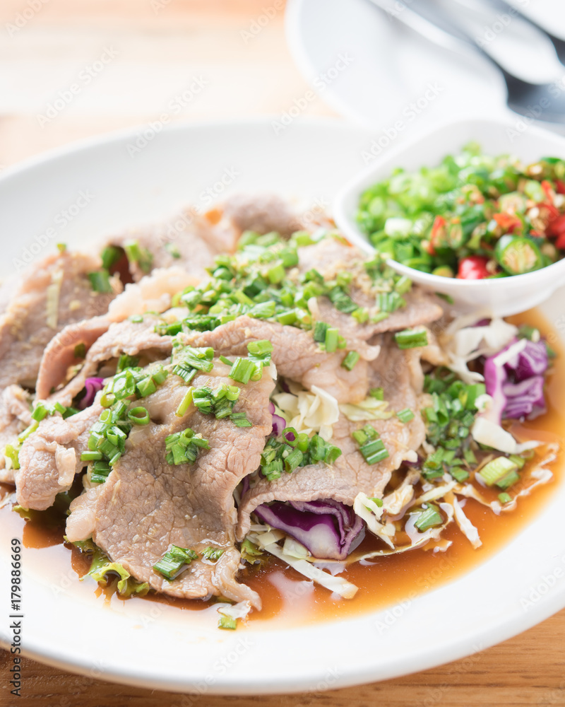 Spicy stir fried pork stips with pepper chilli on wood,thai food Spicy stir fried pork stips with pepper chilli on wood,thai food