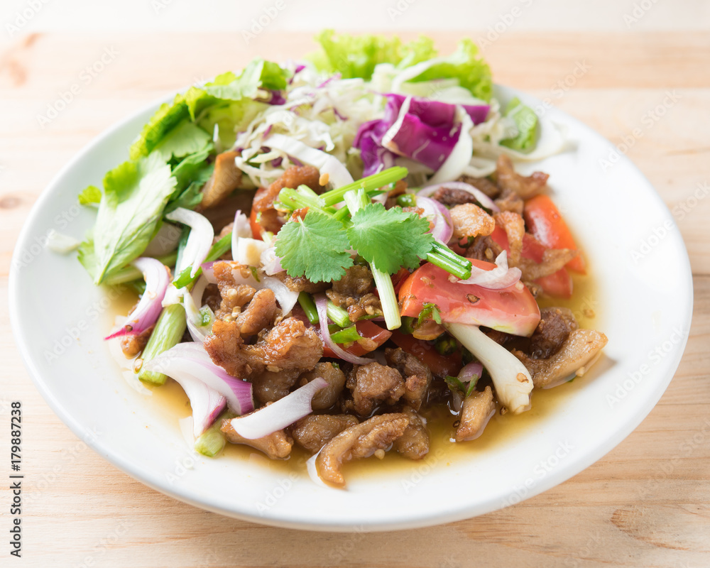 Spicy stir fried pork stips with pepper chilli on wood,thai food Spicy stir fried pork stips with pepper chilli on wood,thai food
