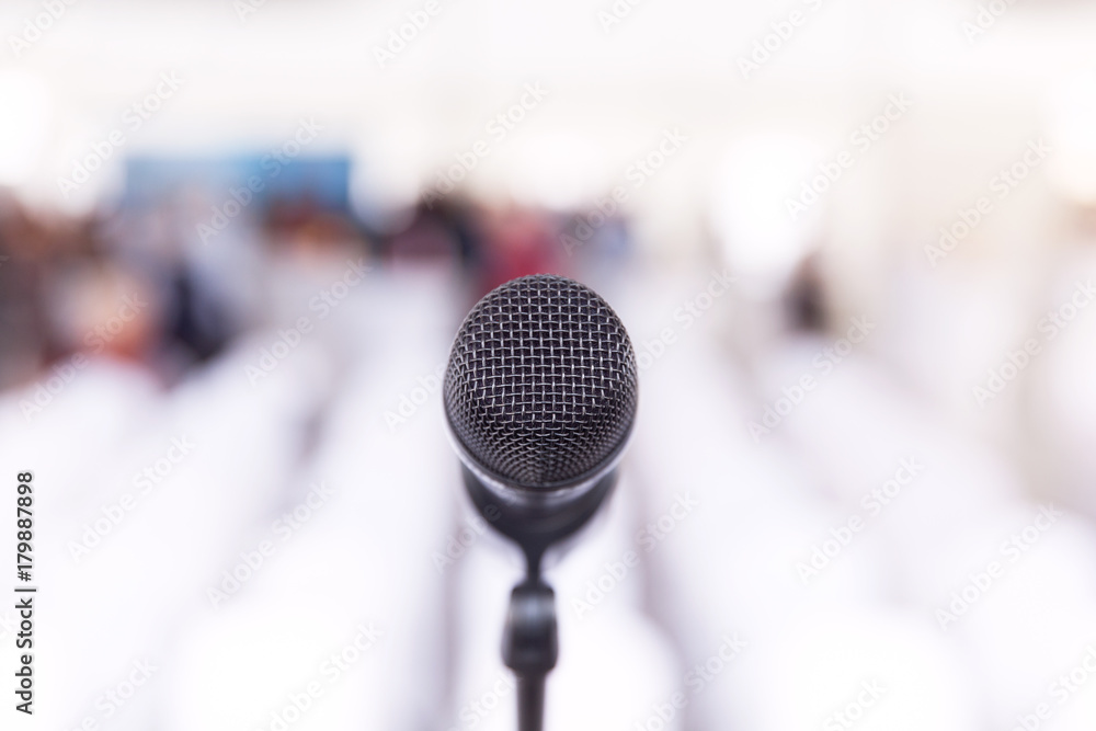 Microphone in focus, conference hall without auditorium in the background Microphone in focus, conference hall without auditorium in the background