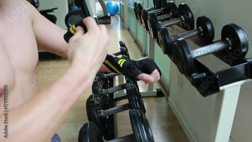 Close up a man is rolling strap on his wrist,protect wrist from hurt
