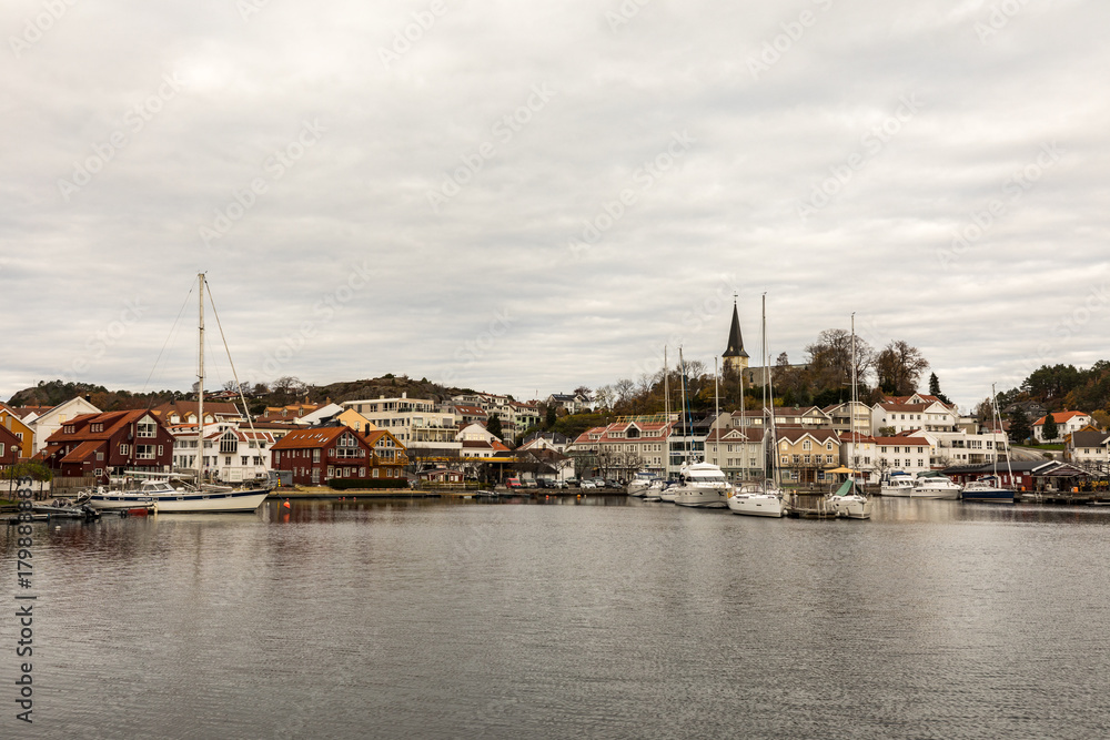 Grimstad, Norway - October 31 2017: Grimstad harbor and city seen from a distance, Norway, Europe. Panorama