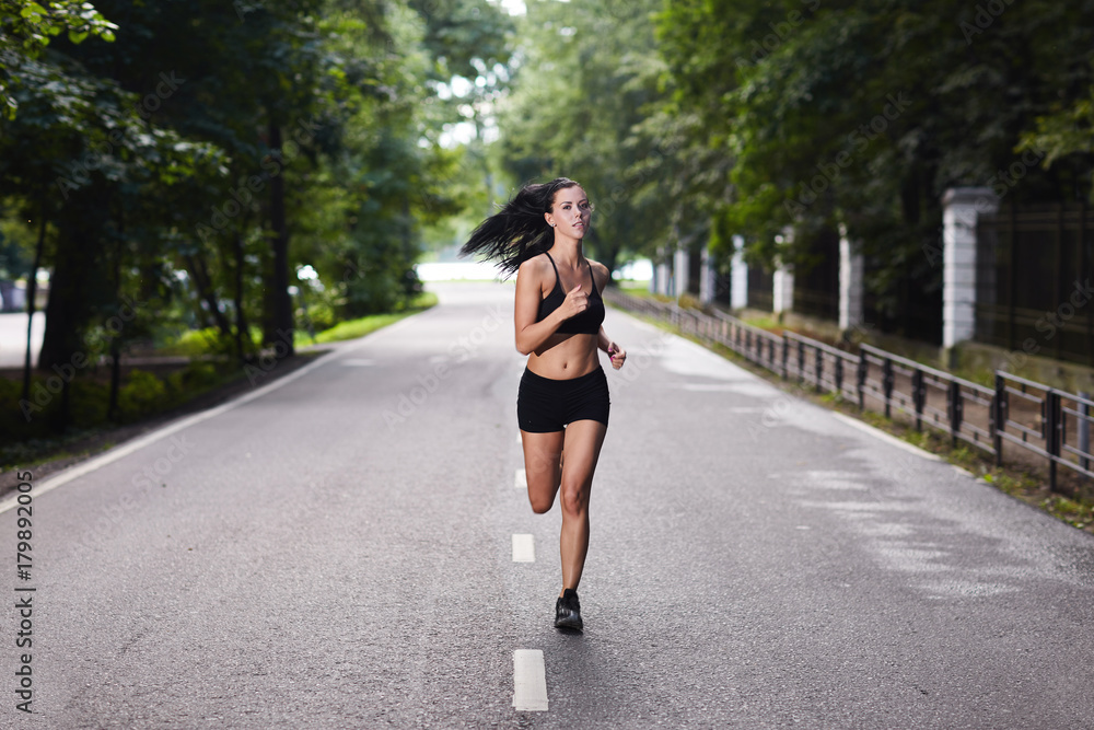 Brunette girl doing a morning jog in the Park. Brunette girl doing a morning jog in the Park.