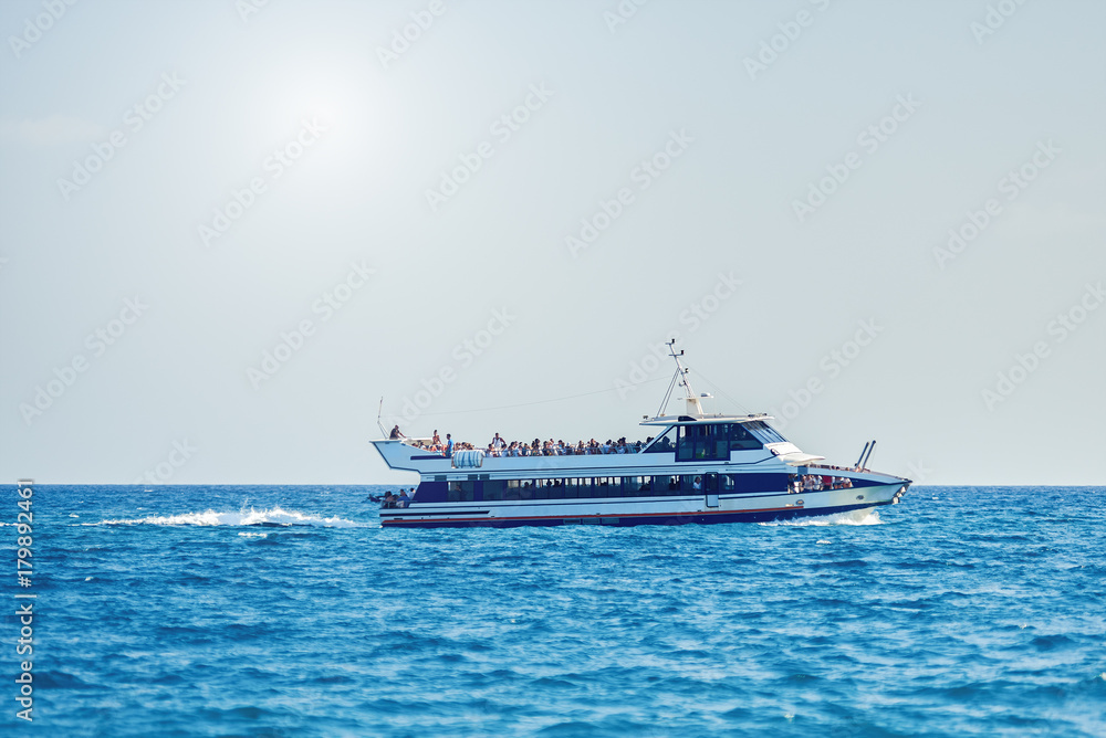 Touristic ship sailing in sea.