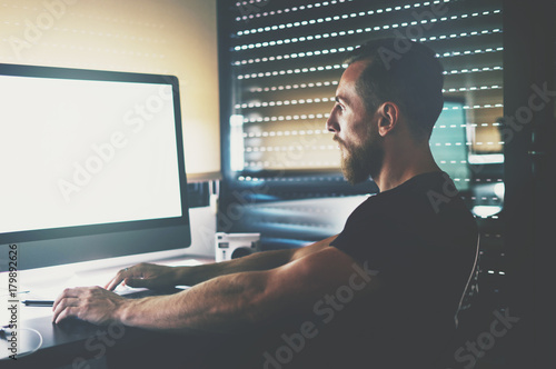 computer. Muscular handsome guy 
