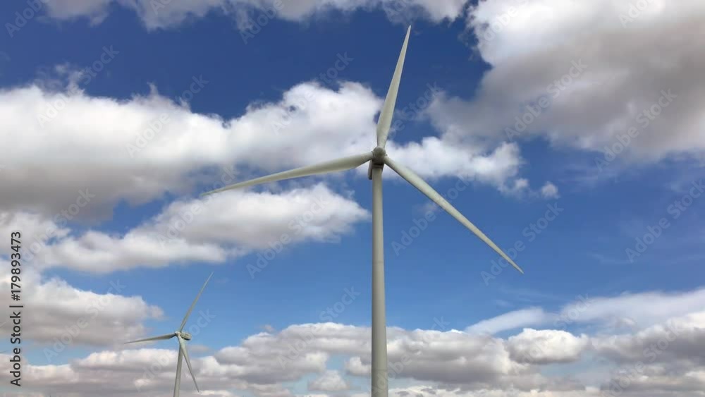 Working wind turbine video. Blue sky with clouds background Working wind turbine video. Blue sky with clouds background