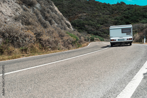 Motorhome driving on winding mountain road. Sardinia. Italy. © ysbrandcosijn