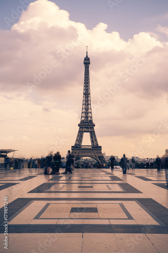 Eiffel tower, Paris symbol and iconic landmark in France, on a cloudy day. Famous touristic places and romantic travel destinations in Europe. Cityscape and tourism concept. Long exposure. Toned © sergiymolchenko