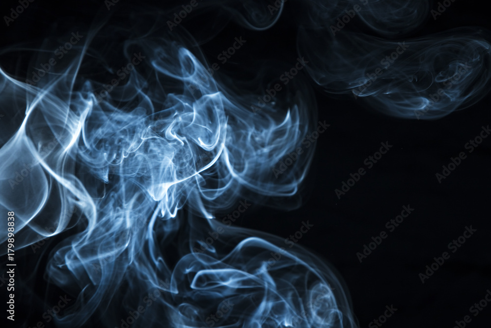 Fototapeta premium Blue smoke on black background