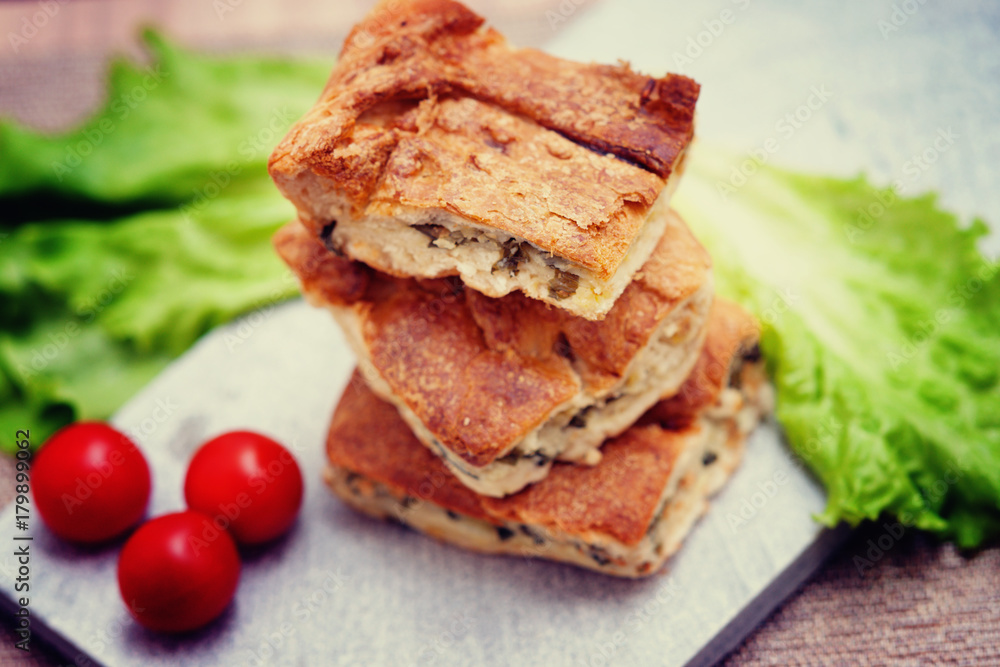 Pie with meat and fresh vegetables on plate Pie with meat and fresh vegetables on plate