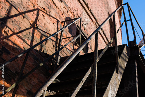 Metal staircase with brick wall, soft focus