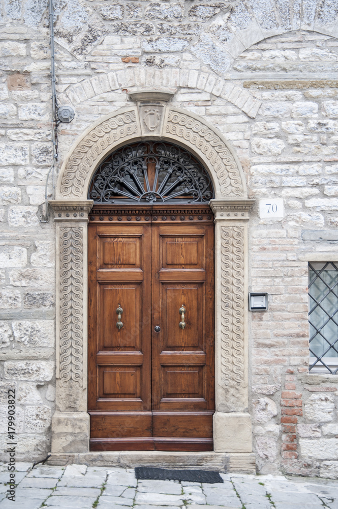 Gubbio, Perugia, Italy - entrance door, architectural details of the ancient palaces Gubbio, Perugia, Italy - entrance door, architectural details of the ancient palaces