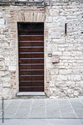 Gubbio, Perugia, Italy - entrance door, architectural details of the ancient palaces