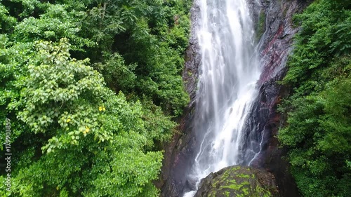 Aerial view in motion of the water flows down the rocky mountain in Adam's Peak in Sri Lanka