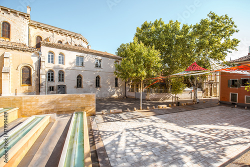 Fototapeta Naklejka Na Ścianę i Meble -  Morning view on the small square near the saint Castor cathedral in Nimes city in the Occitanie region of southern France