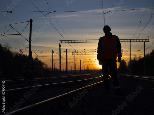 lonely railwayman at work during sunset