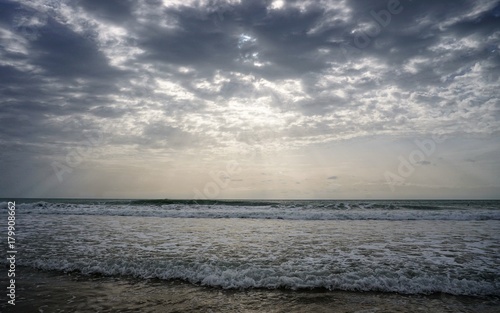 Ocean with waves and clouds and sunlight